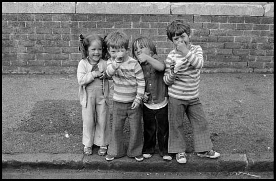 three kids on the pavement